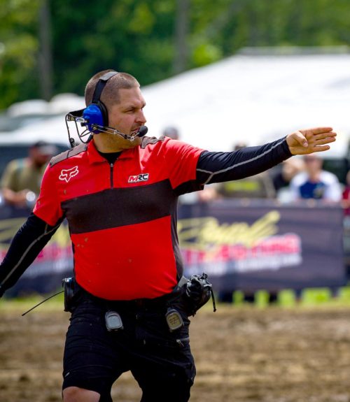 An MRC official checking that riders are ready to start racing.